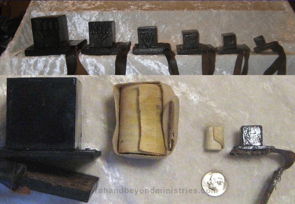 The Scribe Various size Tefillin also called phylacteries are a set of small black leather boxes containing scrolls of parchment inscribed with verses from the Torah,